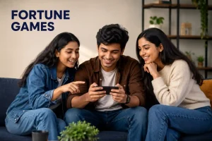 Three Indian Gen Z friends—two women and one man—smile while using a smartphone together in a modern indoor setting, representing the Fortune Games platform in a clean, editorial-style featured image without gambling-related visuals.