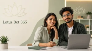 Featured image for “Lotus Bet 365” showing a smiling Indian Gen Z woman and man seated at a modern desk with a smartphone, laptop, notebook, and small plant, set in a clean, softly lit office space with subtle lotus graphics and minimal editorial-style text.